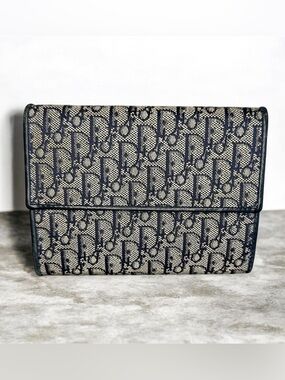 Christian Dior Oblique Jacquard wallet in navy/beige.
Retail price: ~$550–$750